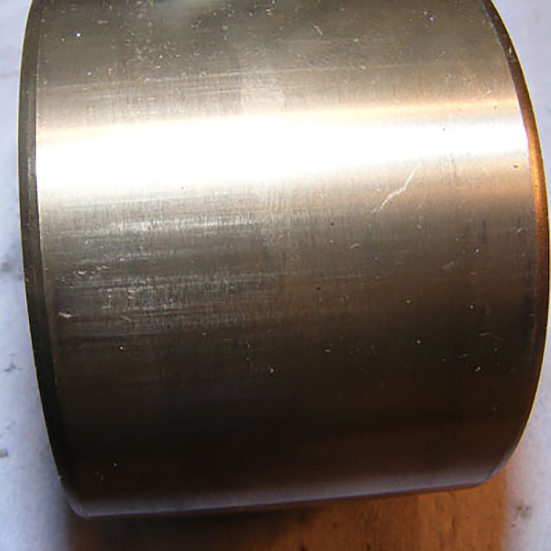 Outer surface scratches caused during fitting. These marks are generally not detrimental to the bearing performance but do show that an interference fit was present between the bearing outer ring and the housing